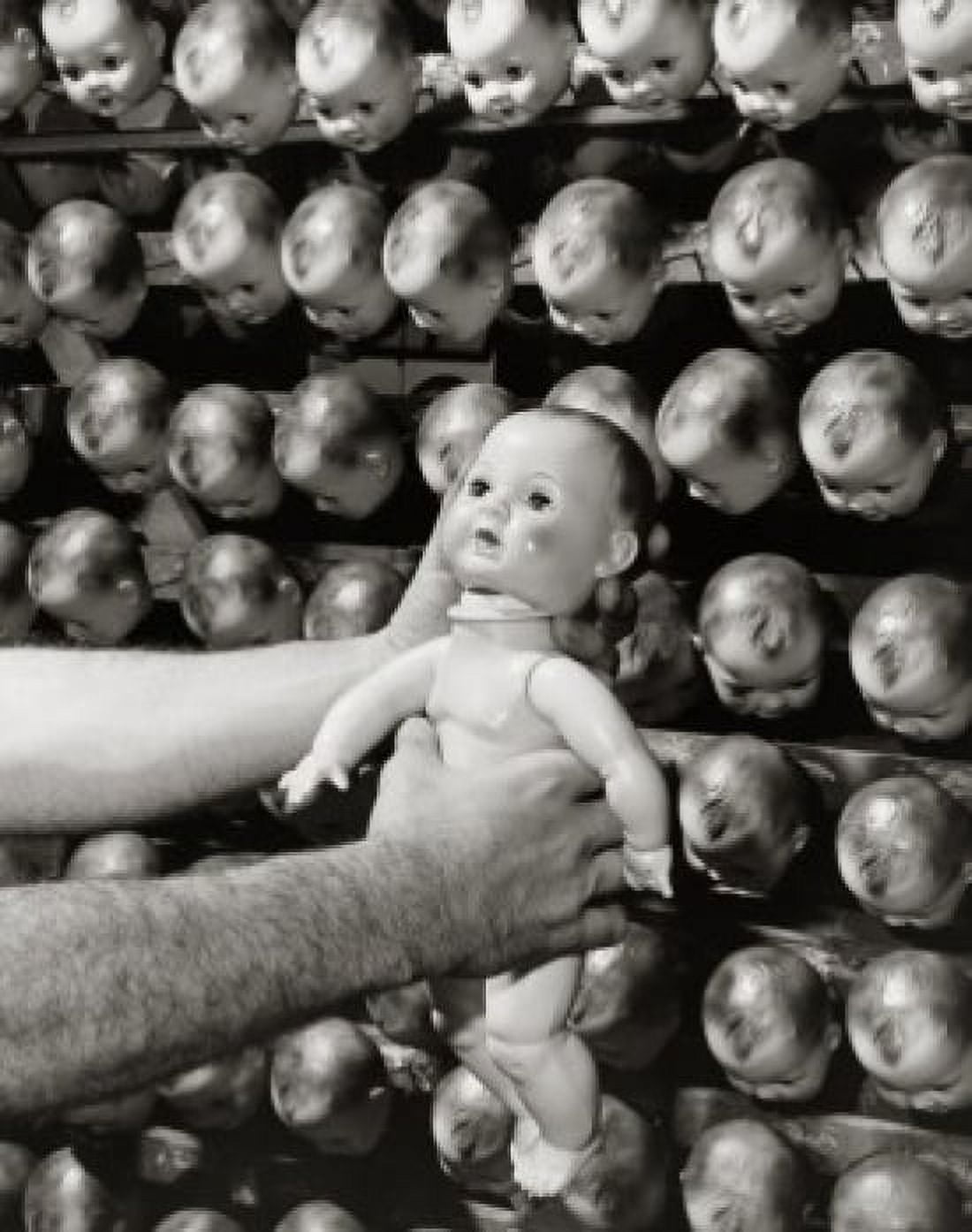 Close-up of a mans hand fixing the head of a doll Canvas Art - (18 x 24)