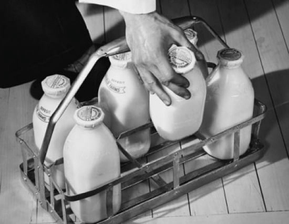Close-up of a mans hand picking up a milk bottle Canvas Art - (18 x 24)