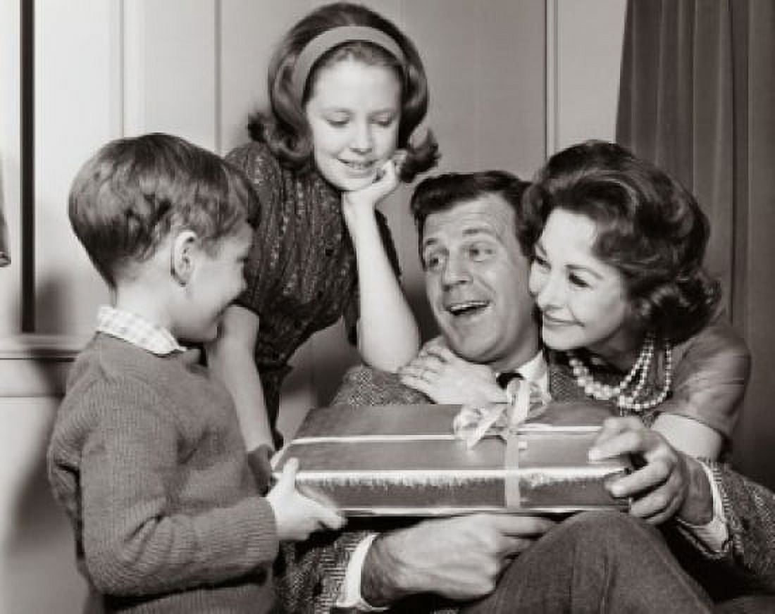 Close-up of a mature couple giving a birthday present to their son and their daughter standing beside them Canvas Art - (24 x 36)