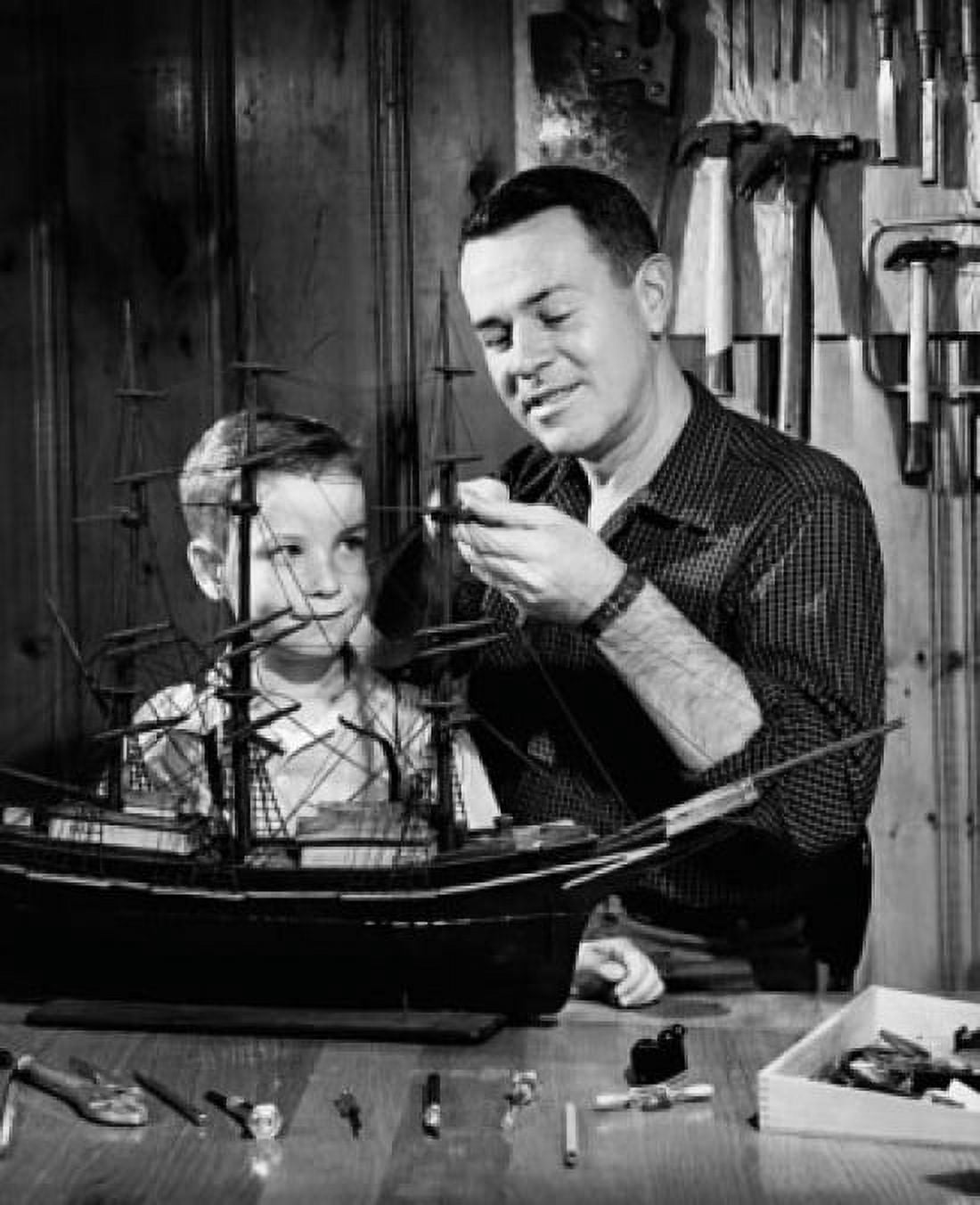 Close-up of a mature man with his son making a model of a sailing ship Canvas Art - (18 x 24)