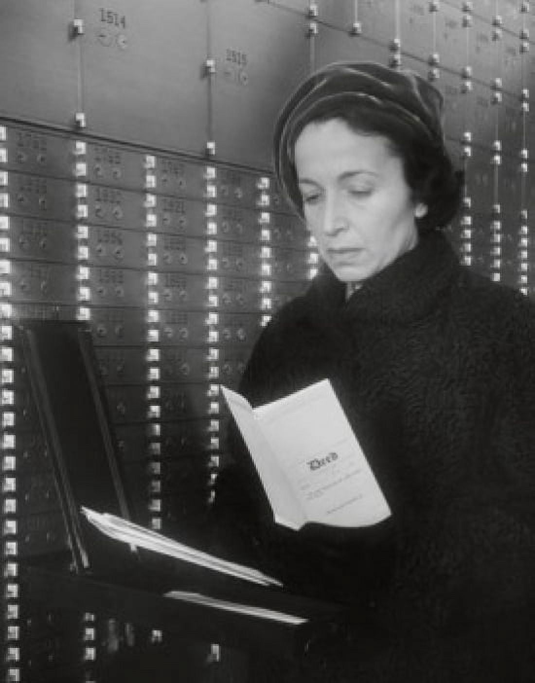 Close-up of a mature woman reading a document in a safety box deposit room Canvas Art - (18 x 24)