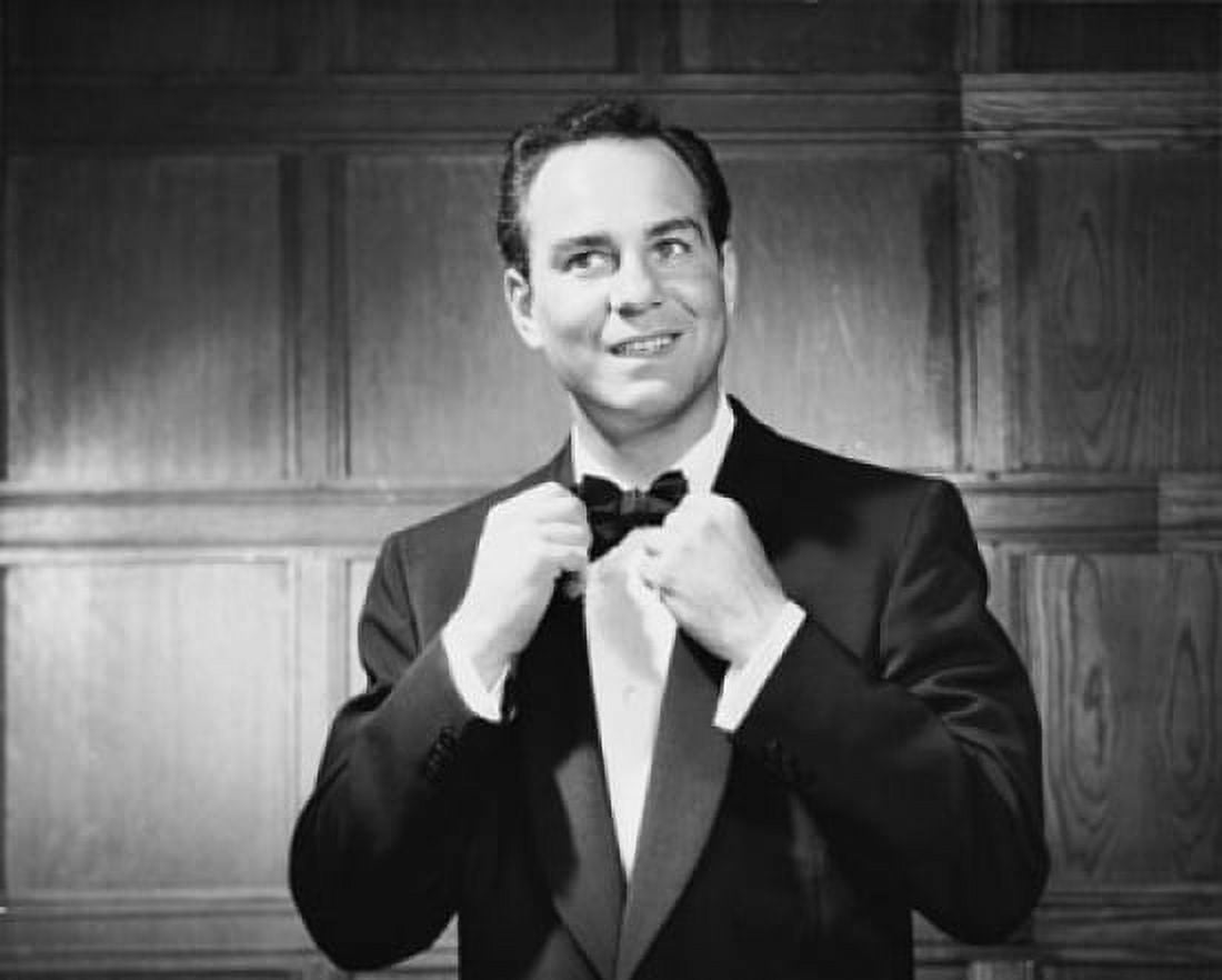 Close-up of a mid adult man adjusting a bow tie and smiling Canvas Art - (18 x 24)