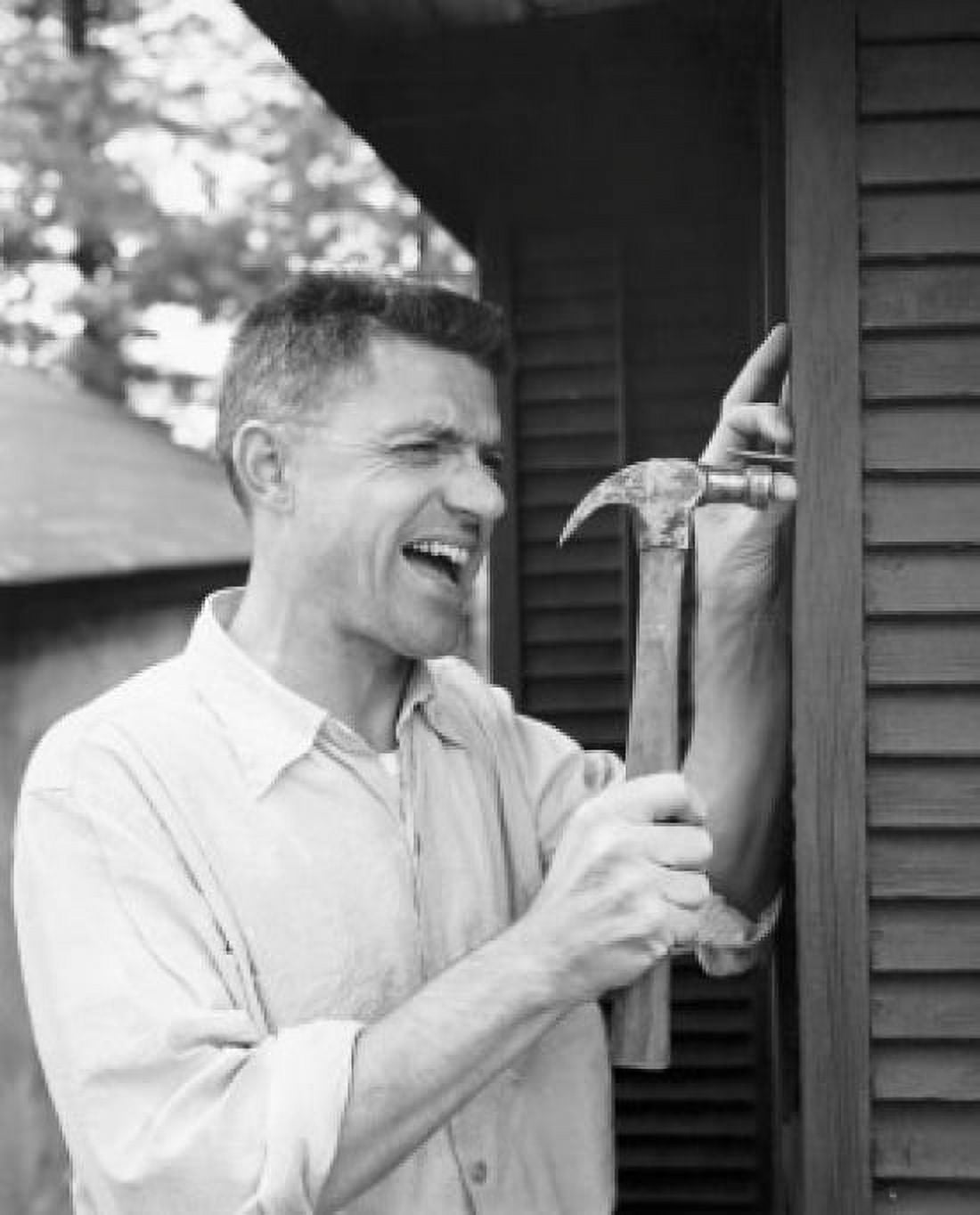 Close-up of a mid adult man hitting his thumb with a hammer Canvas Art - (24 x 36)