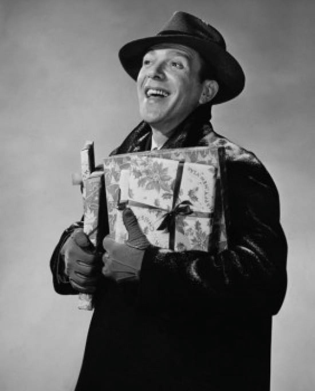 Close-up of a mid adult man holding Christmas presents and smiling Canvas Art - (18 x 24)