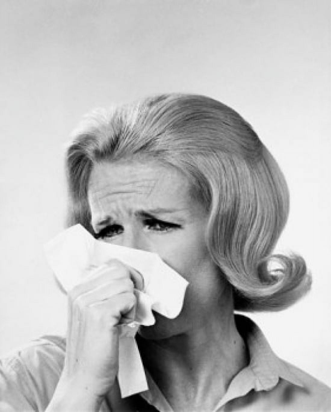 Close-up of a mid adult woman blowing her nose in a handkerchief Canvas Art - (18 x 24)