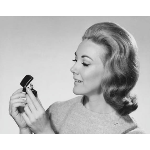 Close-up of a mid adult woman holding a jewelry box and smiling Poster Print (24 x 36)