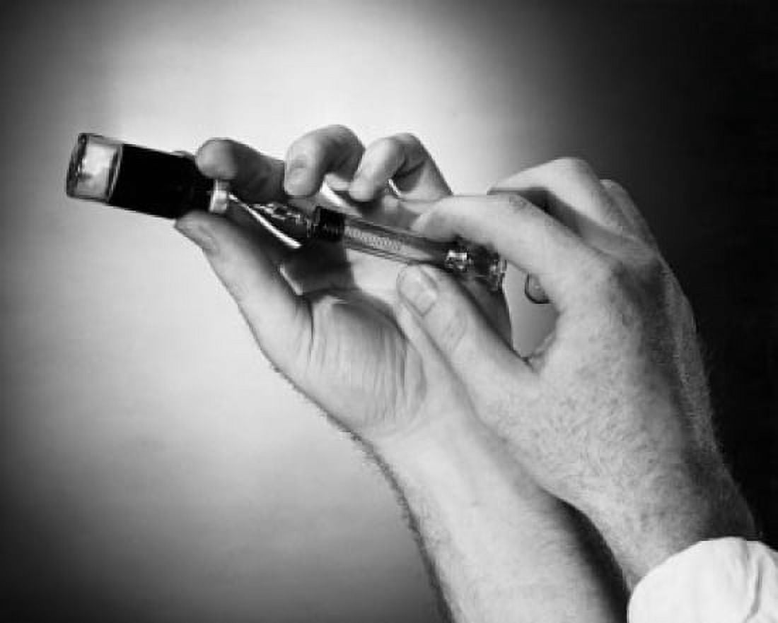 Close-up of a persons hand filling a syringe from a vial Canvas Art - (18 x 24)