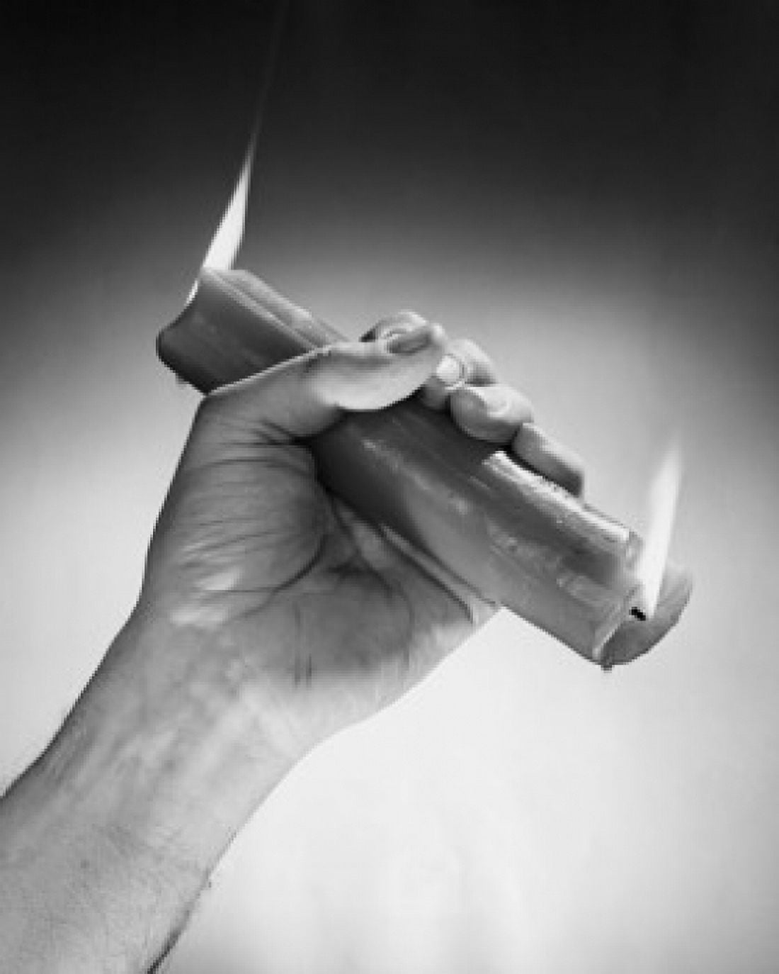Close-up of a persons hand holding a candle burning at the both ends Canvas Art - (18 x 24)