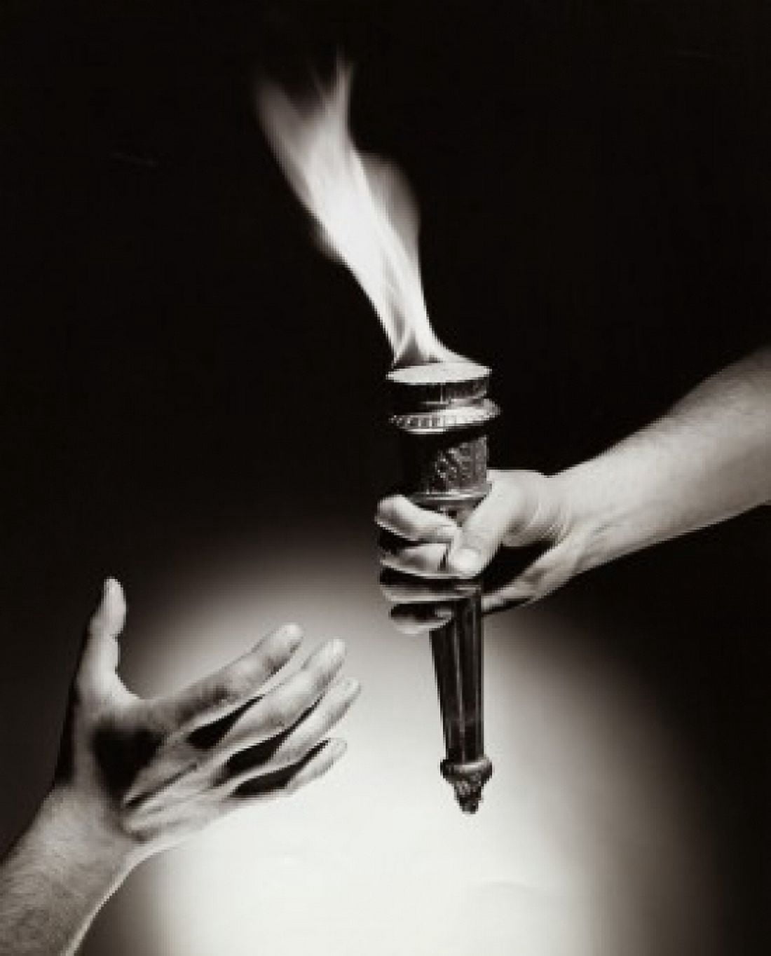 Close-up of a persons hand passing a flaming torch to another person Canvas Art - (18 x 24)