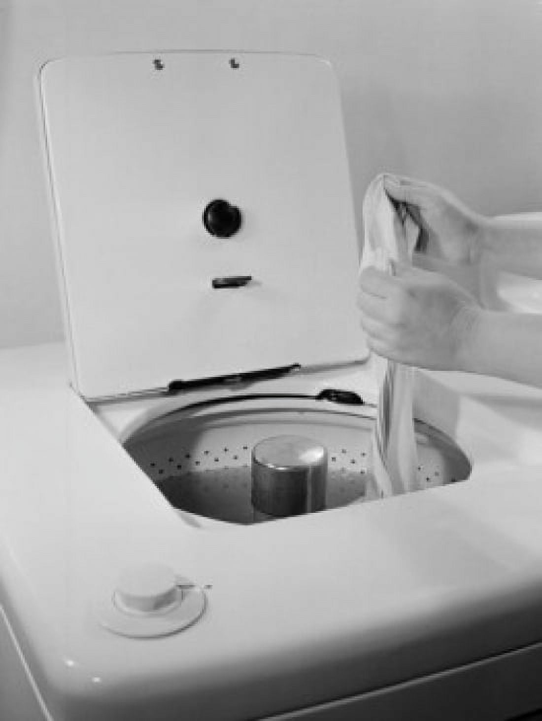 Close-up of a persons hand picking up cloth from a washing machine Canvas Art - (24 x 36)