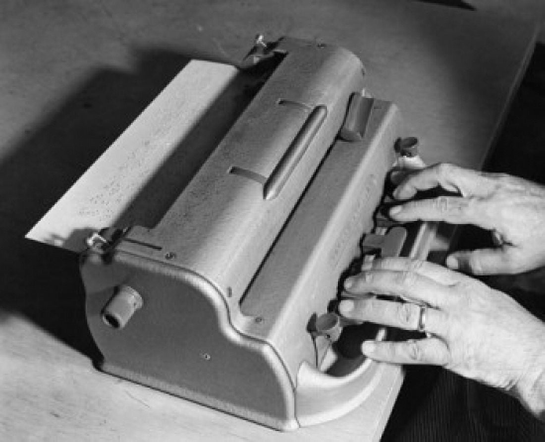 Close-up of a persons hand typing on a Braille typewriter Canvas Art - (24 x 36)