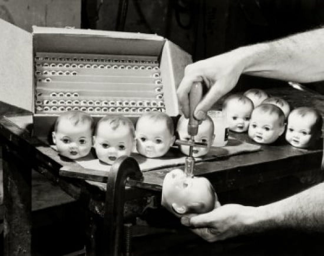 Close-up of a persons hands putting eyes in the head of dolls Canvas Art - (18 x 24)