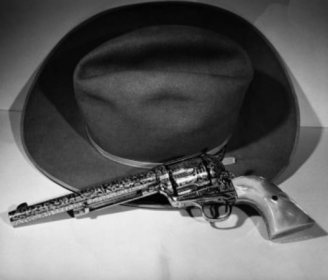 Close-up of a revolver and a hat Canvas Art - (18 x 24)