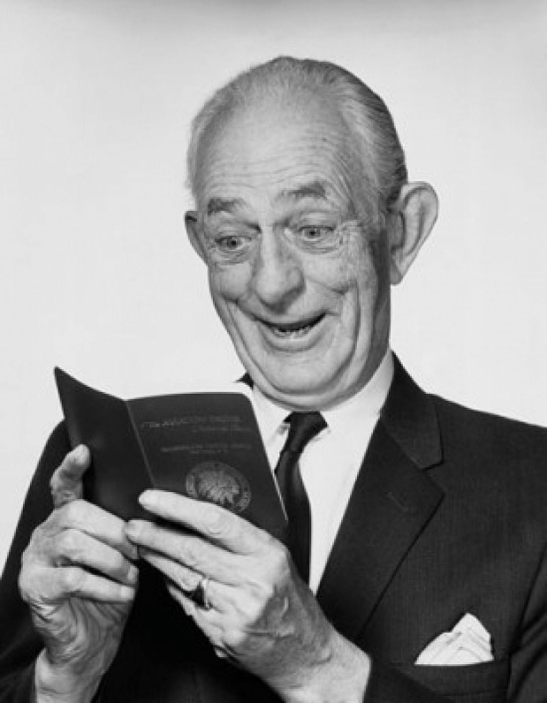 Close-up of a senior man looking at a bankbook and smiling Canvas Art - (18 x 24)
