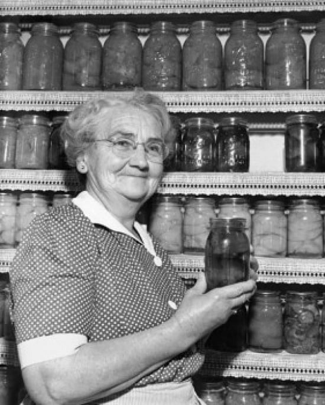 Close-up of a senior woman holding a jar of pickles Canvas Art - (18 x 24)