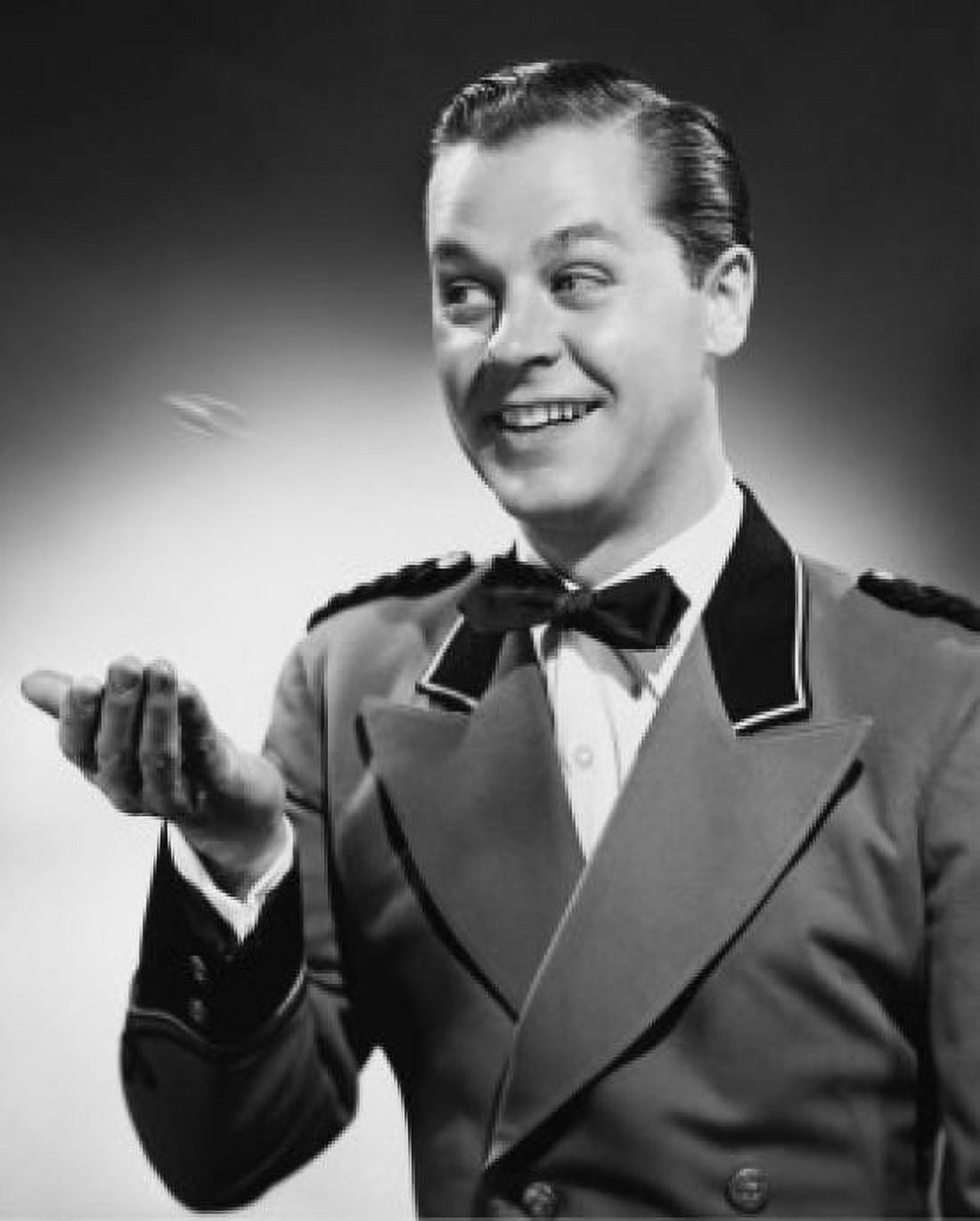 Close-up of a smiling bellhop tossing a coin Canvas Art - (18 x 24)