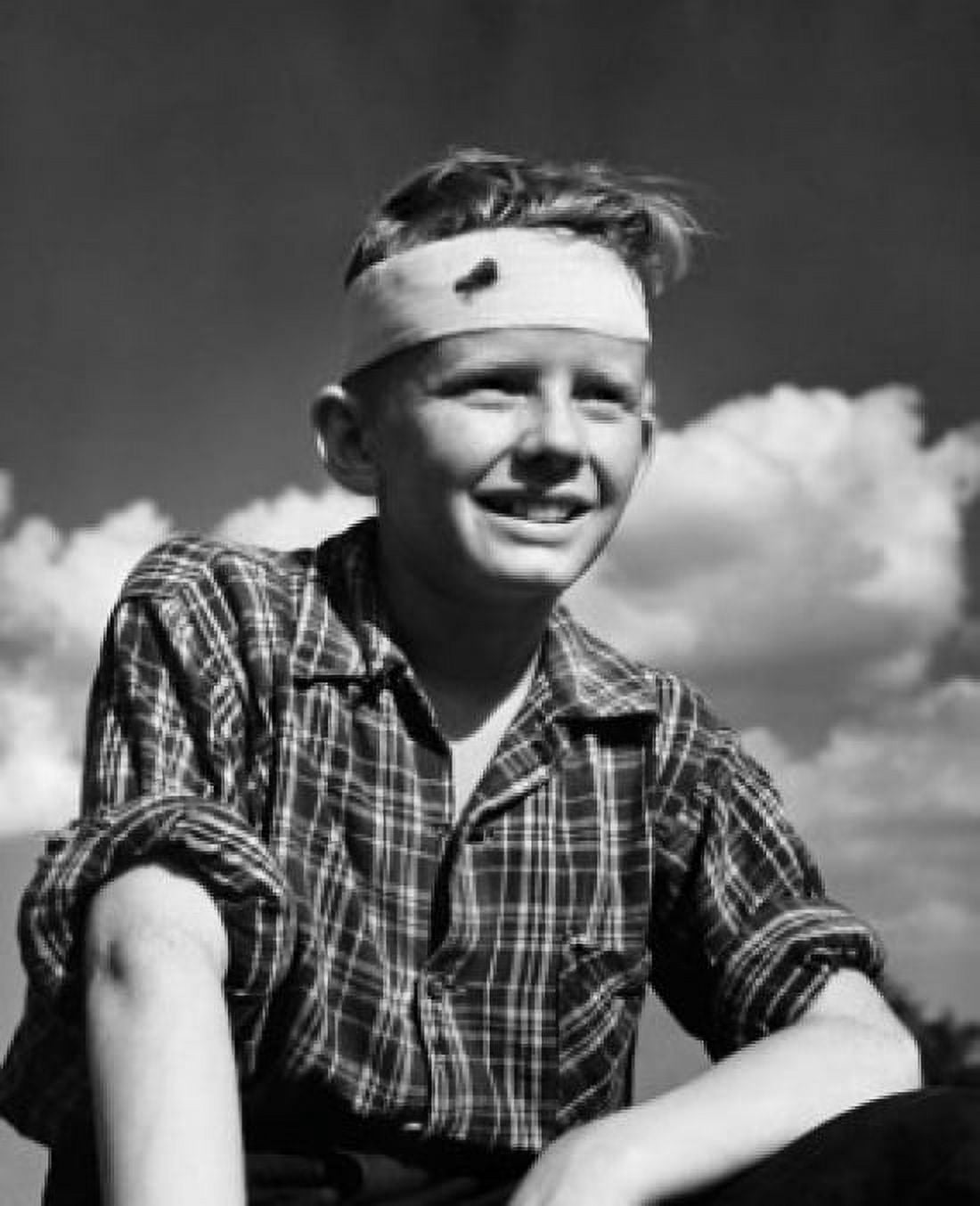 Close-up of a teenage boy with bandage around his forehead Canvas Art - (24 x 36)