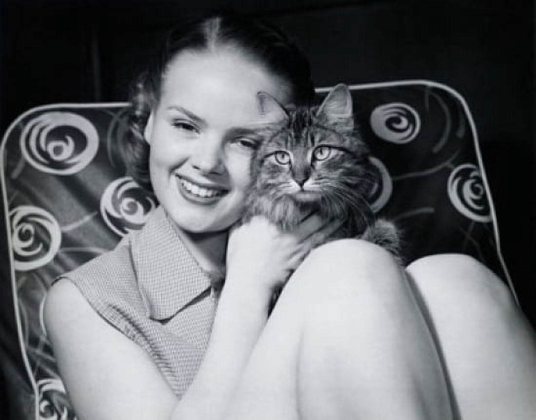 Close-up of a teenage girl hugging a cat and smiling Canvas Art - (18 x 24)