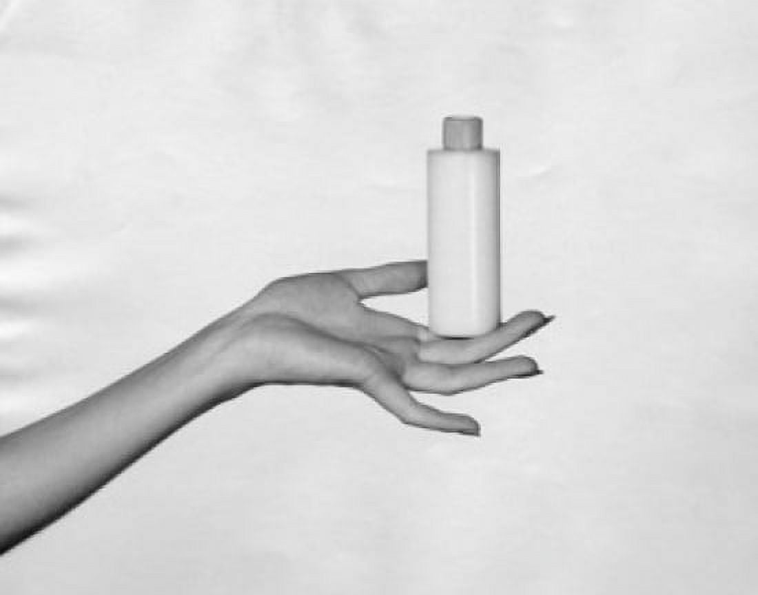 Close-up of a womans hand holding a bottle of moisturizer Canvas Art - (24 x 36)