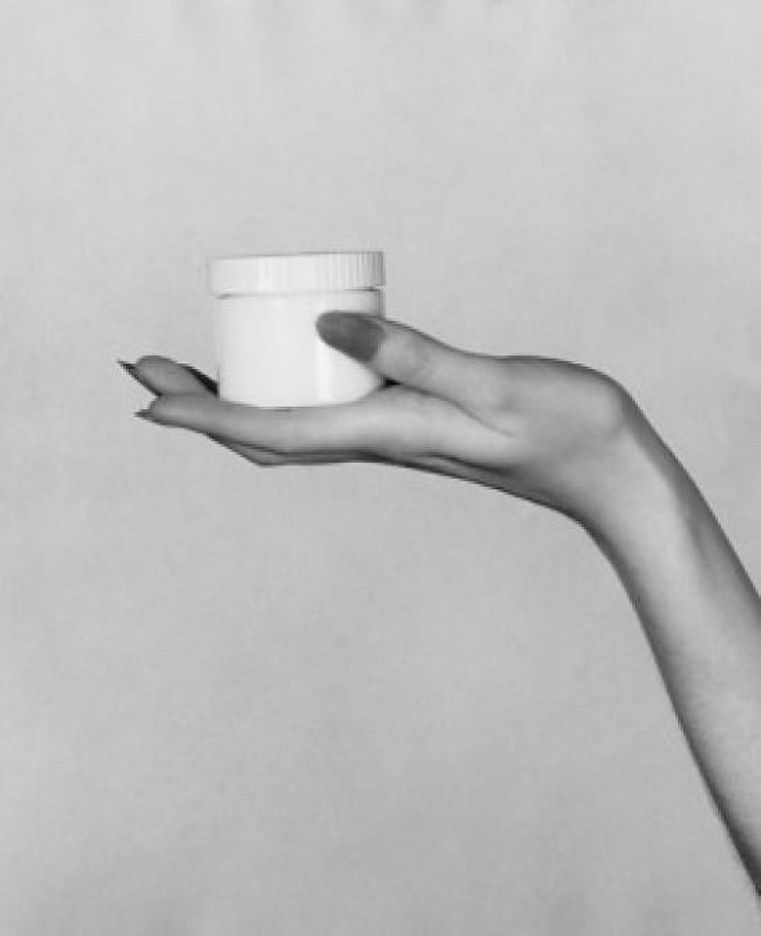 Close-up of a womans hand holding a jar of moisturizer Canvas Art - (18 x 24)