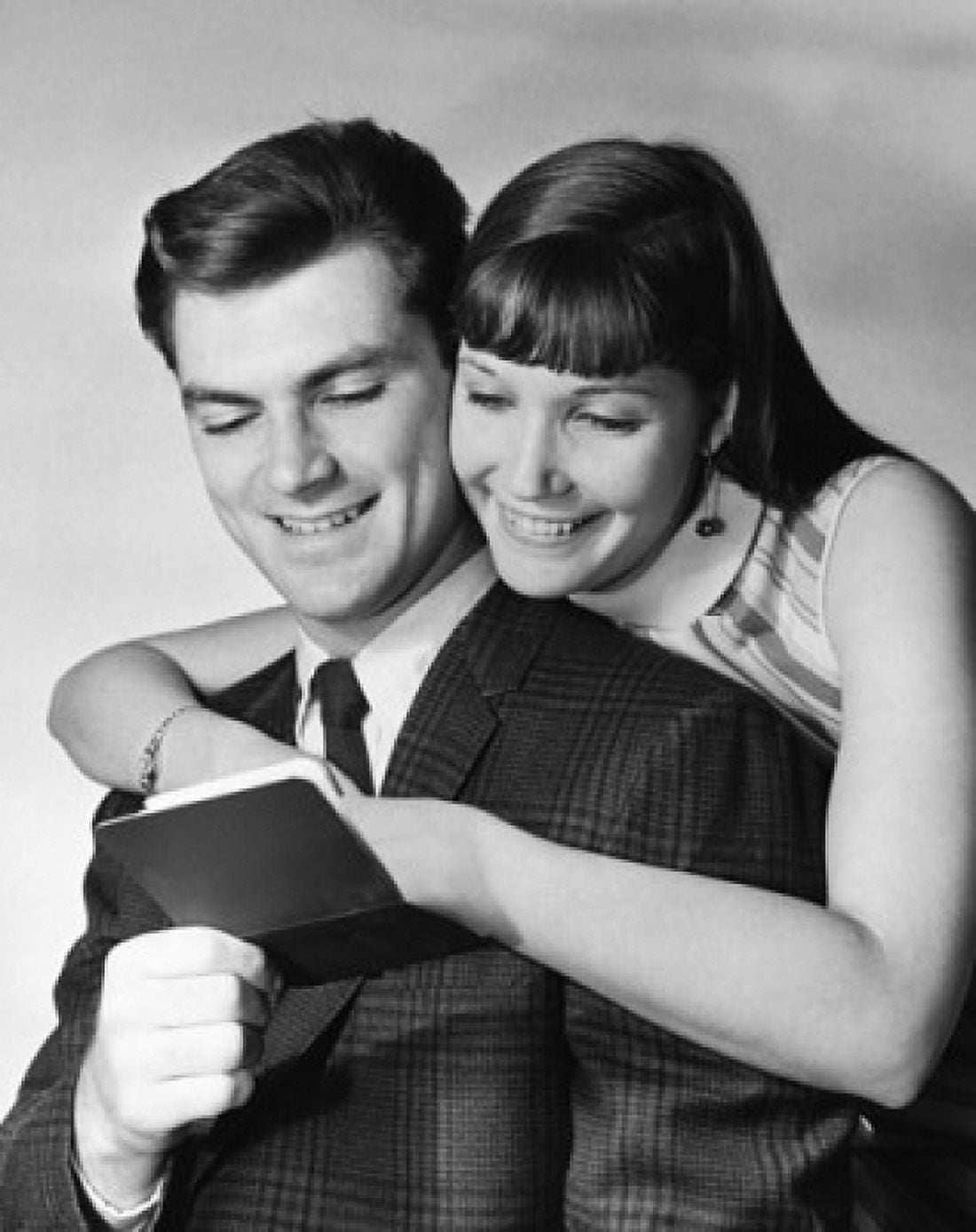 Close-up of a young couple reading a bankbook and smiling Canvas Art - (18 x 24)
