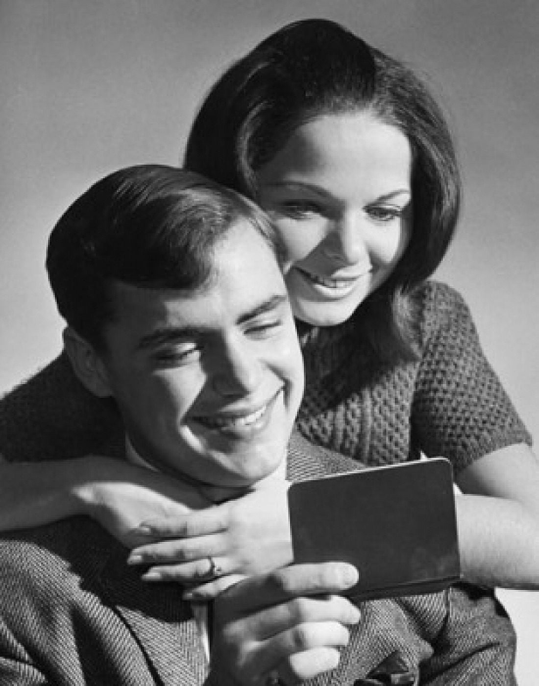 Close-up of a young couple reading a bankbook and smiling Canvas Art - (24 x 36)