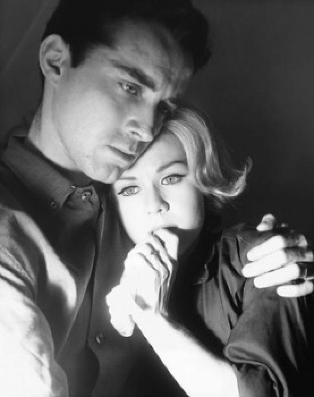 Close-up of a young man embracing a young woman and looking serious Canvas Art - (18 x 24)