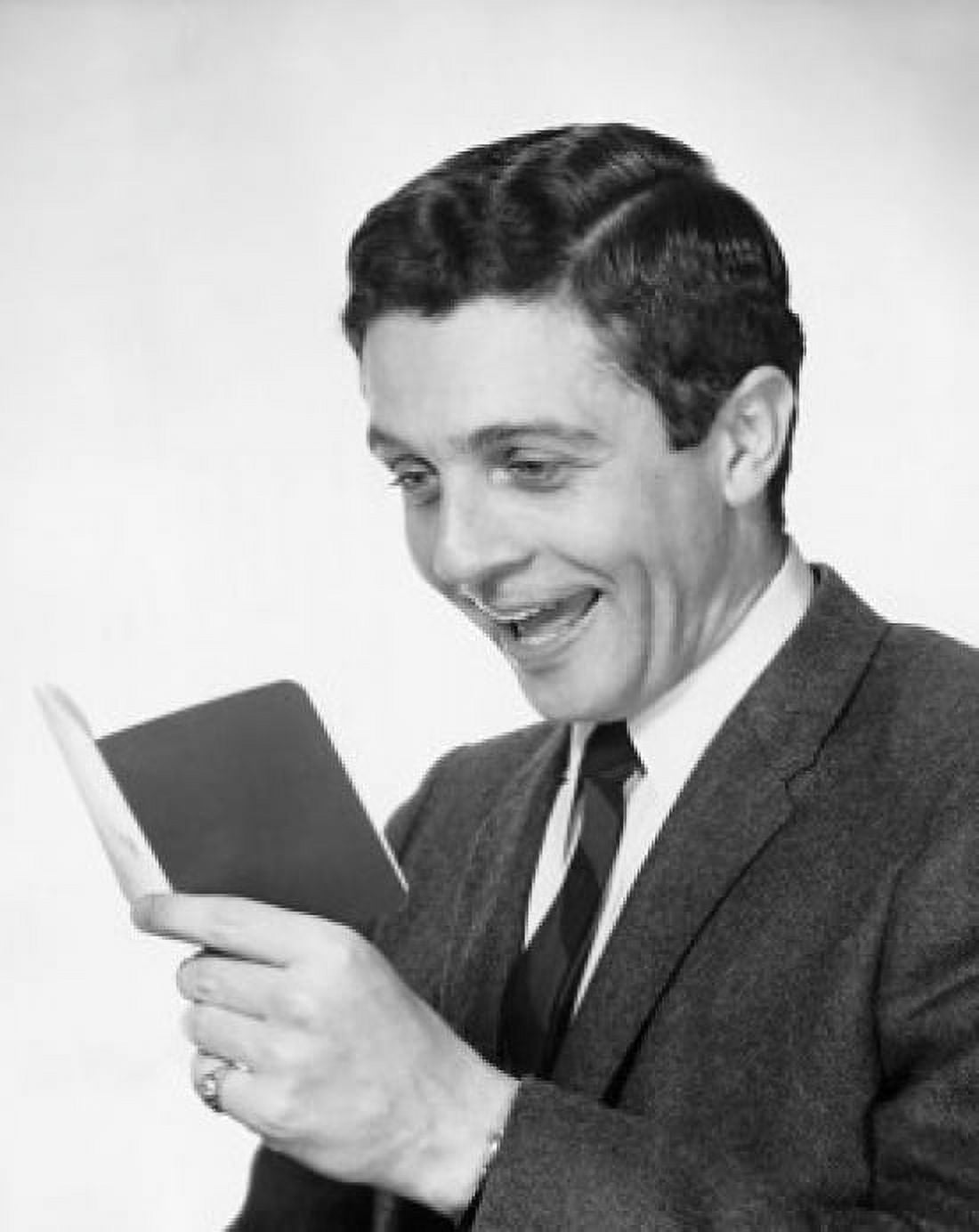 Close-up of a young man holding a bankbook and laughing Canvas Art - (18 x 24)