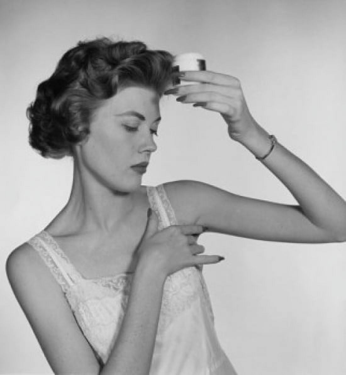 Close-up of a young woman applying deodorant to her armpit Canvas Art - (24 x 36)