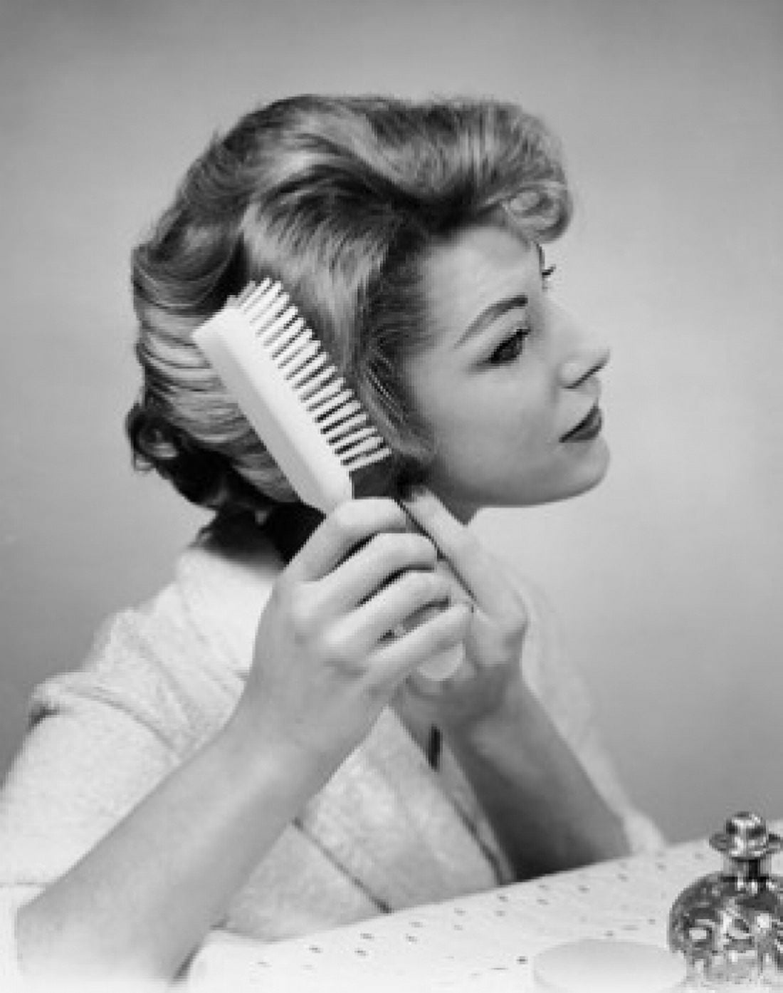 Close-up of a young woman brushing her hair Canvas Art - (24 x 36)