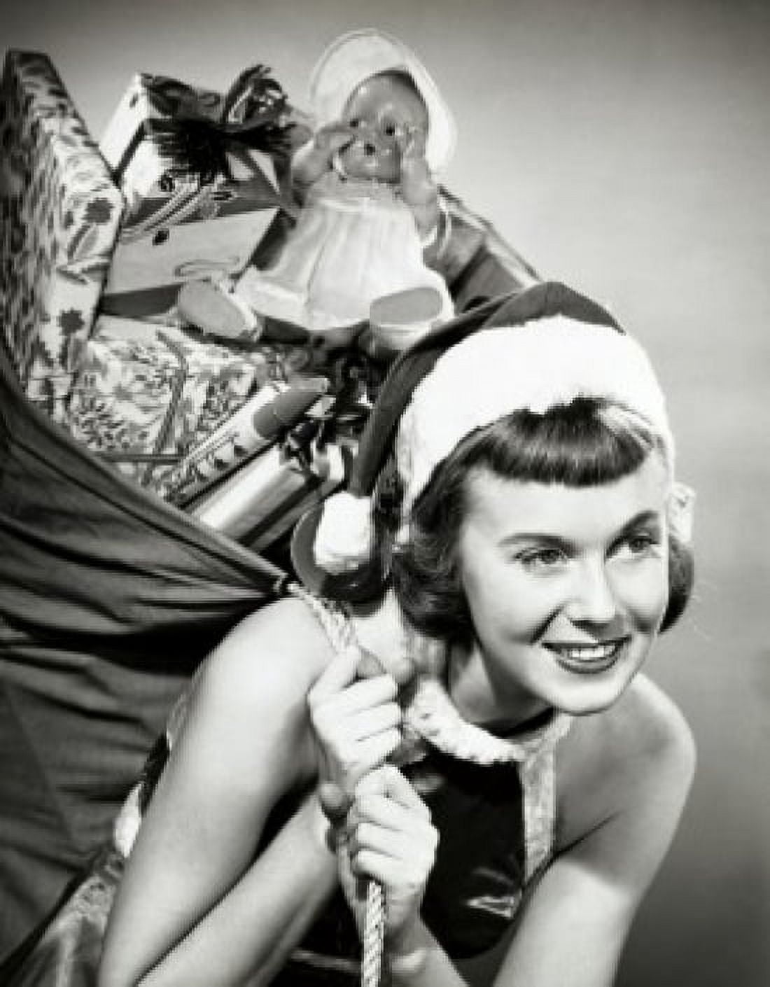 Close-up of a young woman carrying a sack of Christmas presents on her back Canvas Art - (18 x 24)