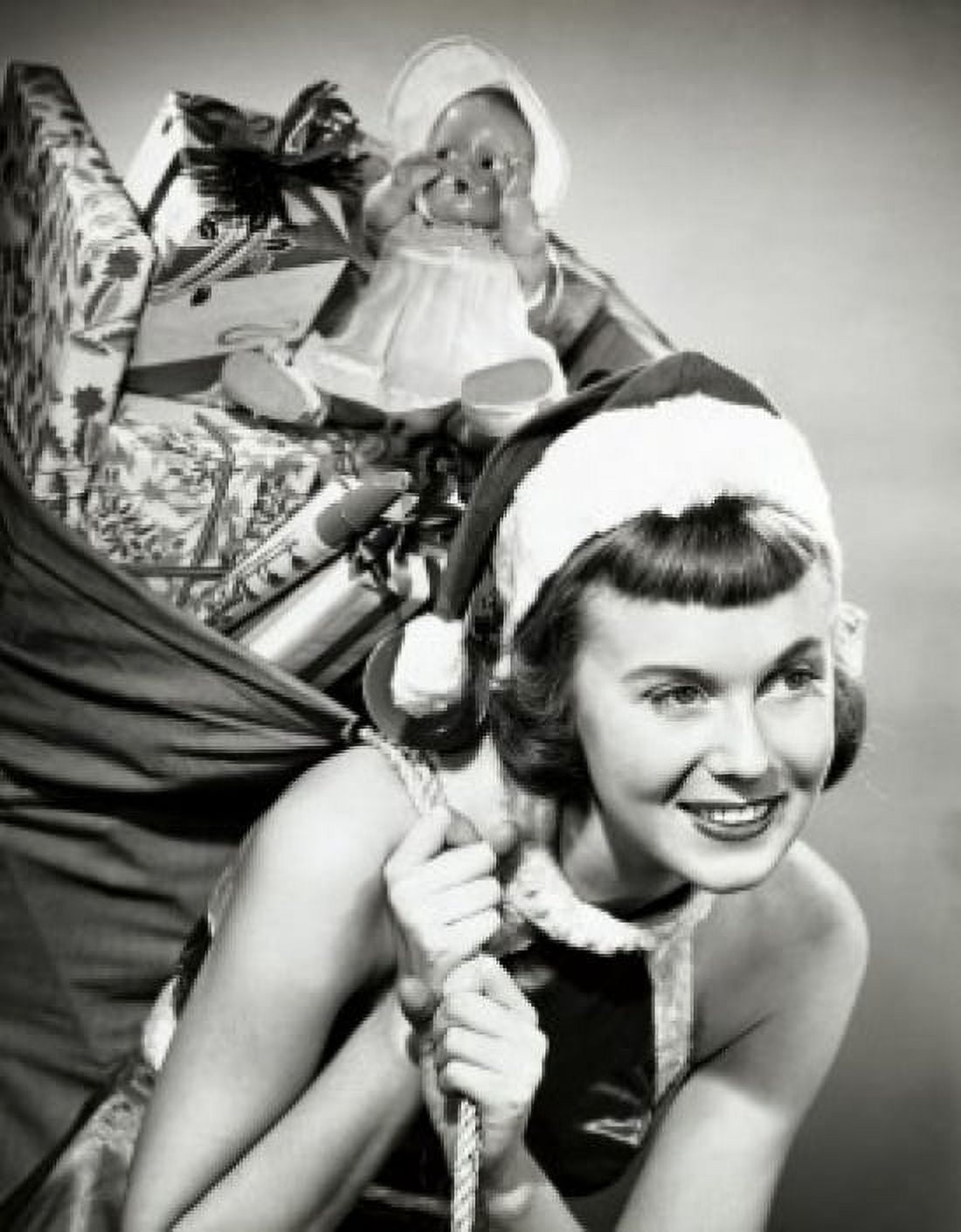 Close-up of a young woman carrying a sack of Christmas presents on her back Canvas Art - (24 x 36)
