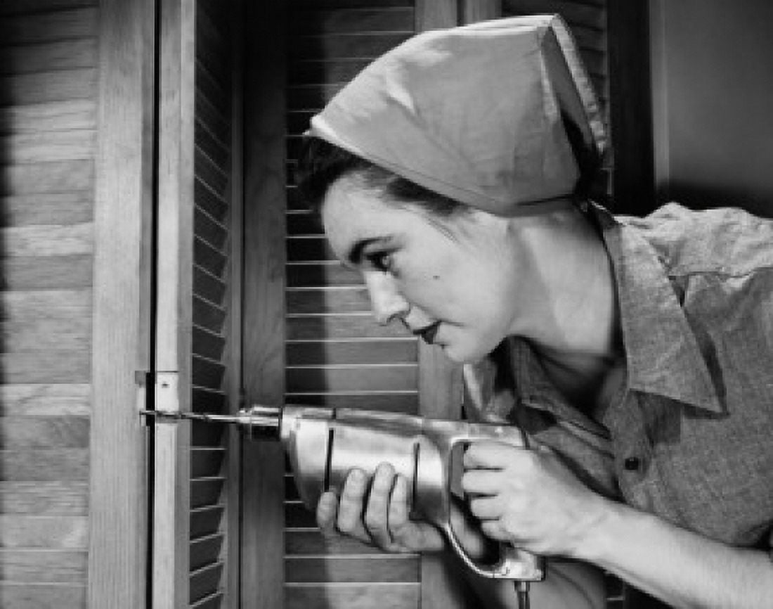 Close-up of a young woman drilling a shutter Canvas Art - (24 x 36)