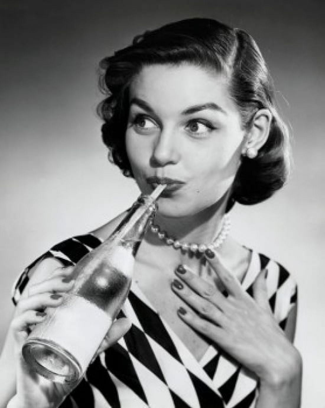 Close-up of a young woman drinking from soda bottle with a drinking straw Canvas Art - (18 x 24)