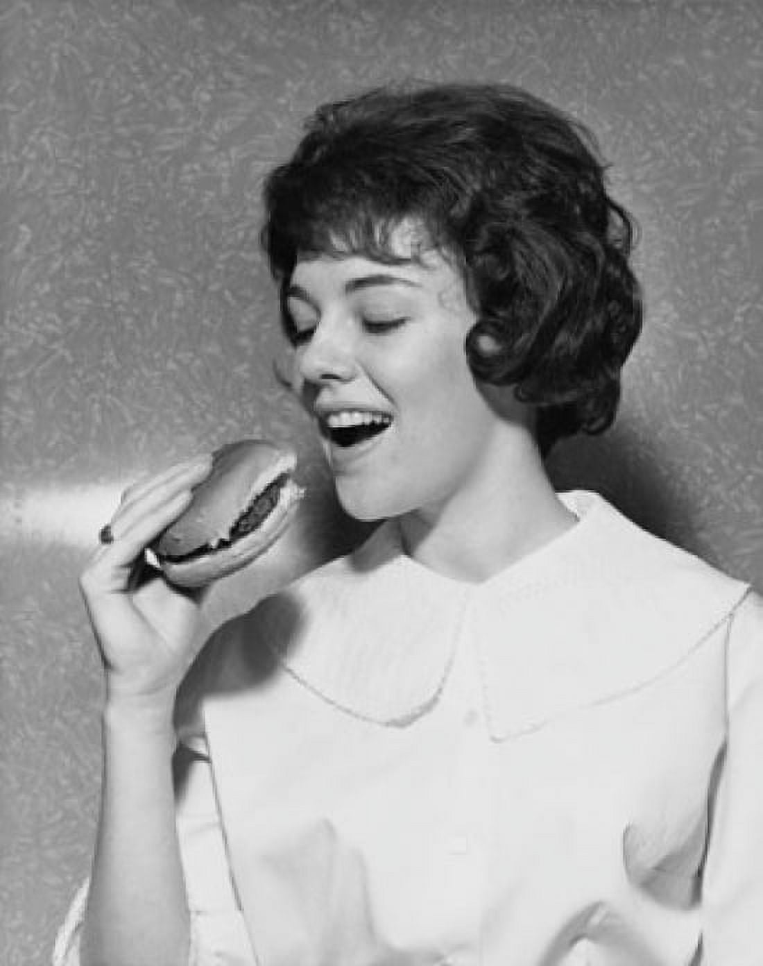 Close-up of a young woman eating a hamburger Canvas Art - (18 x 24)