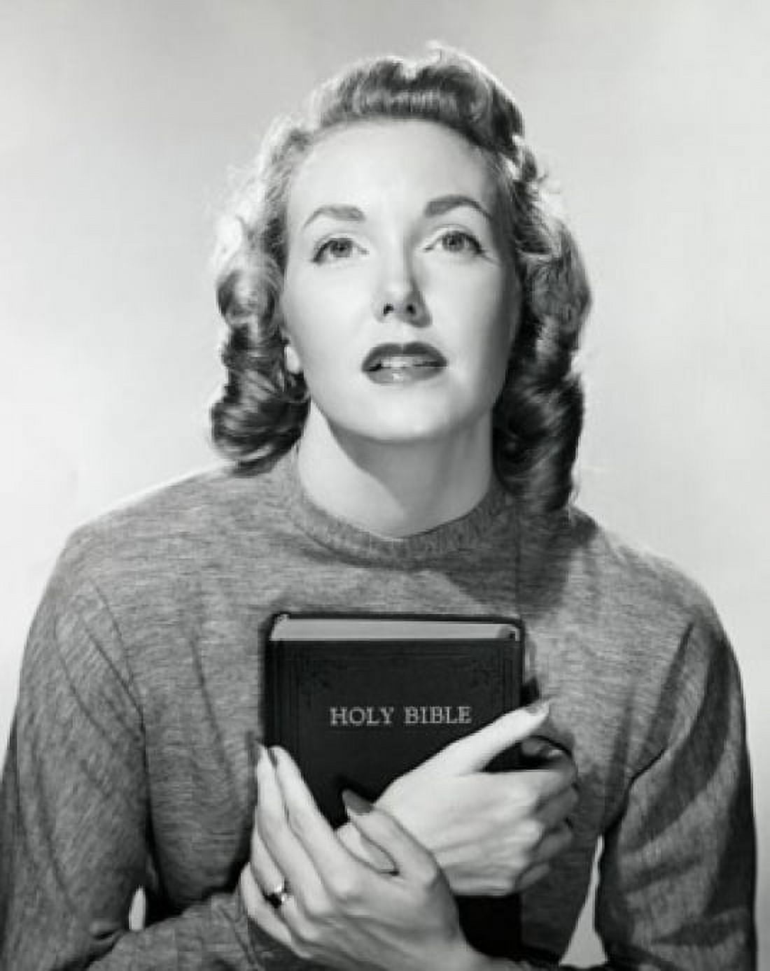 Close-up of a young woman holding the Bible Canvas Art - (18 x 24)