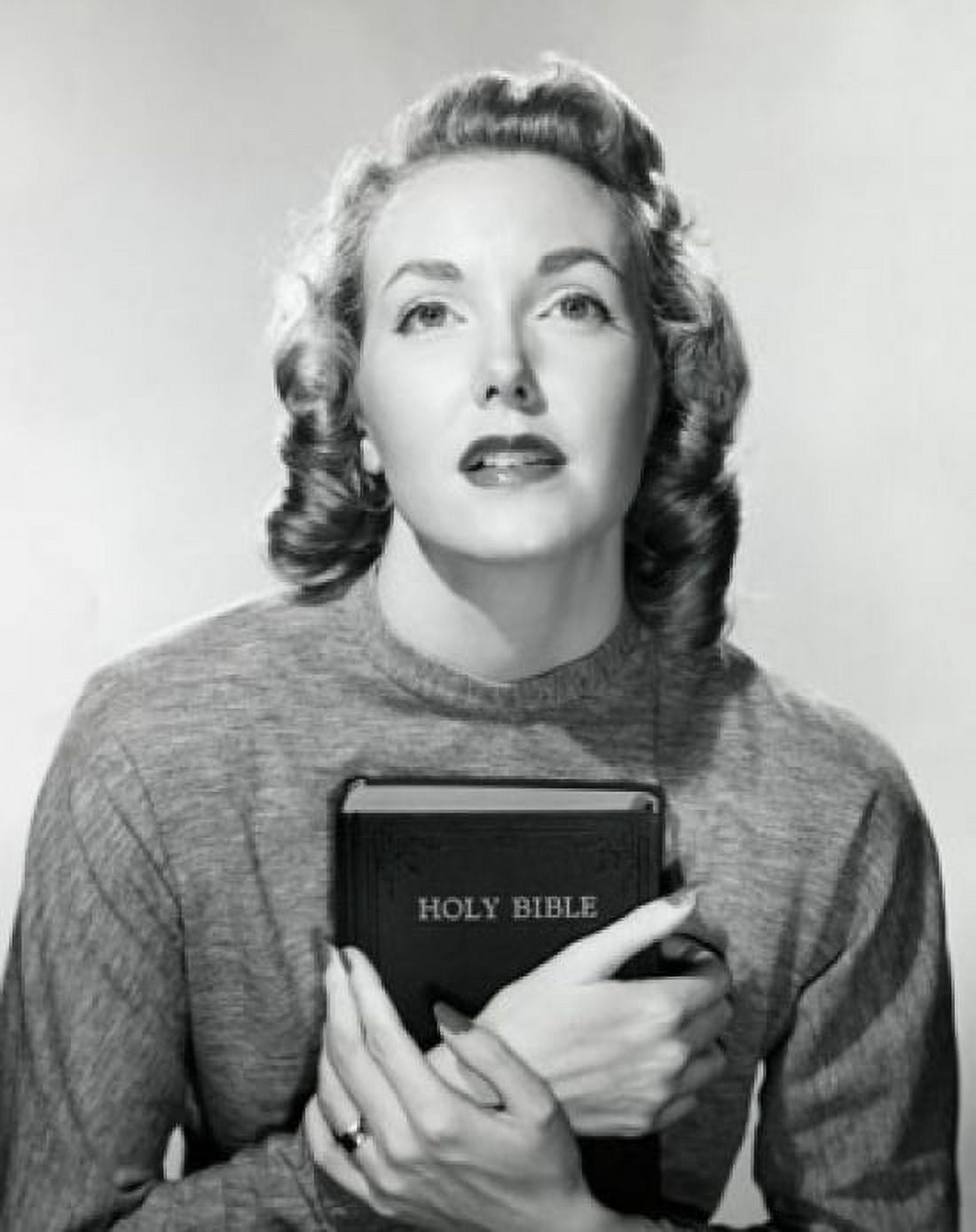 Close-up of a young woman holding the Bible Canvas Art - (24 x 36)
