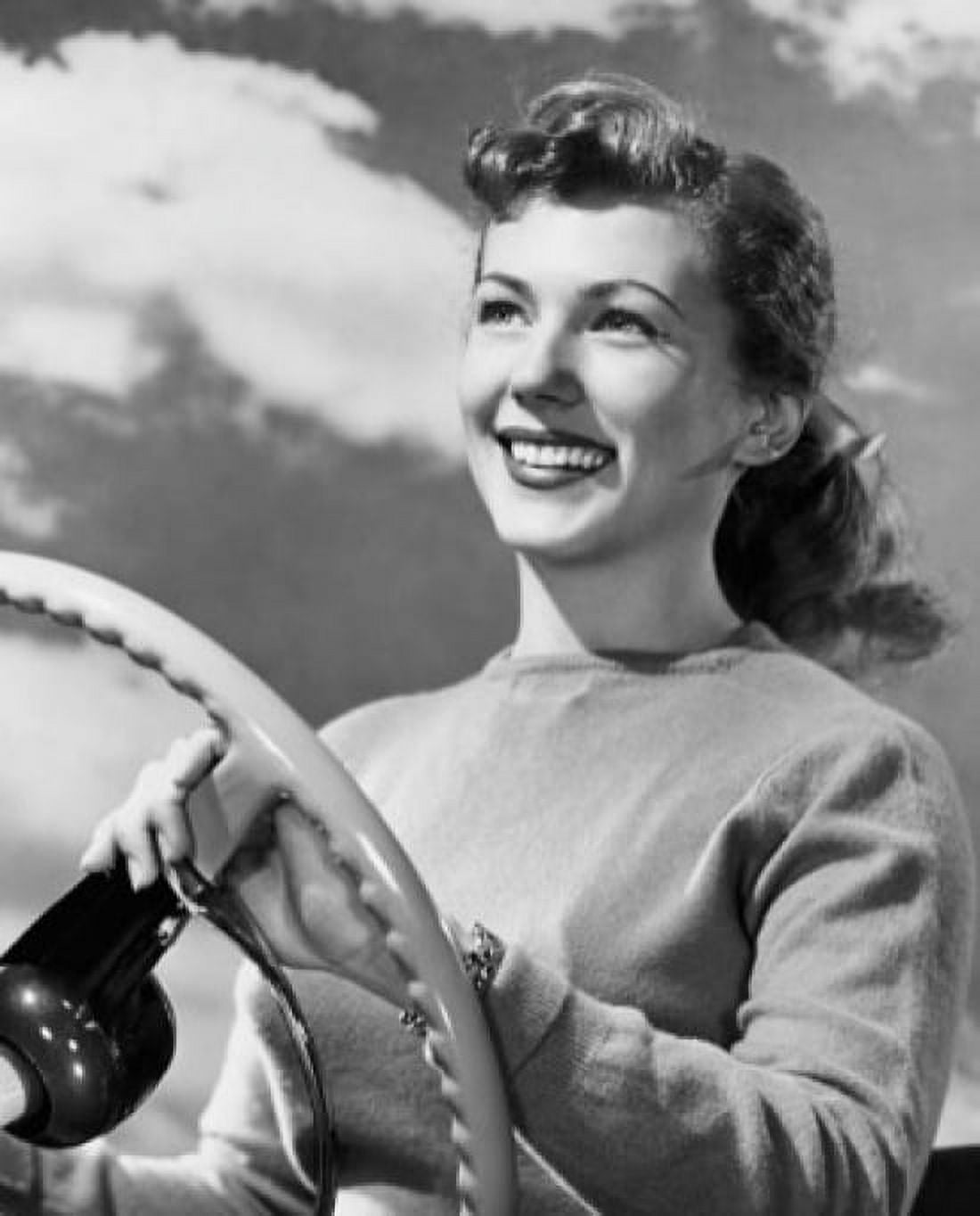 Close-up of a young woman holding the steering wheel of a car and smiling Canvas Art - (24 x 36)