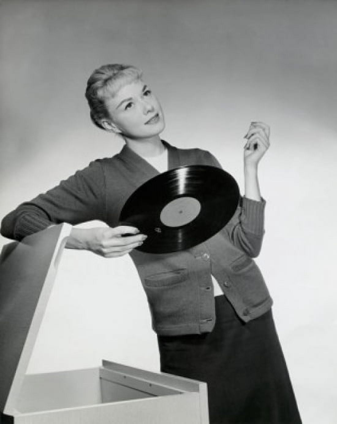 Close-up of a young woman leaning on a box and holding a record 1958 Canvas Art - (18 x 24)