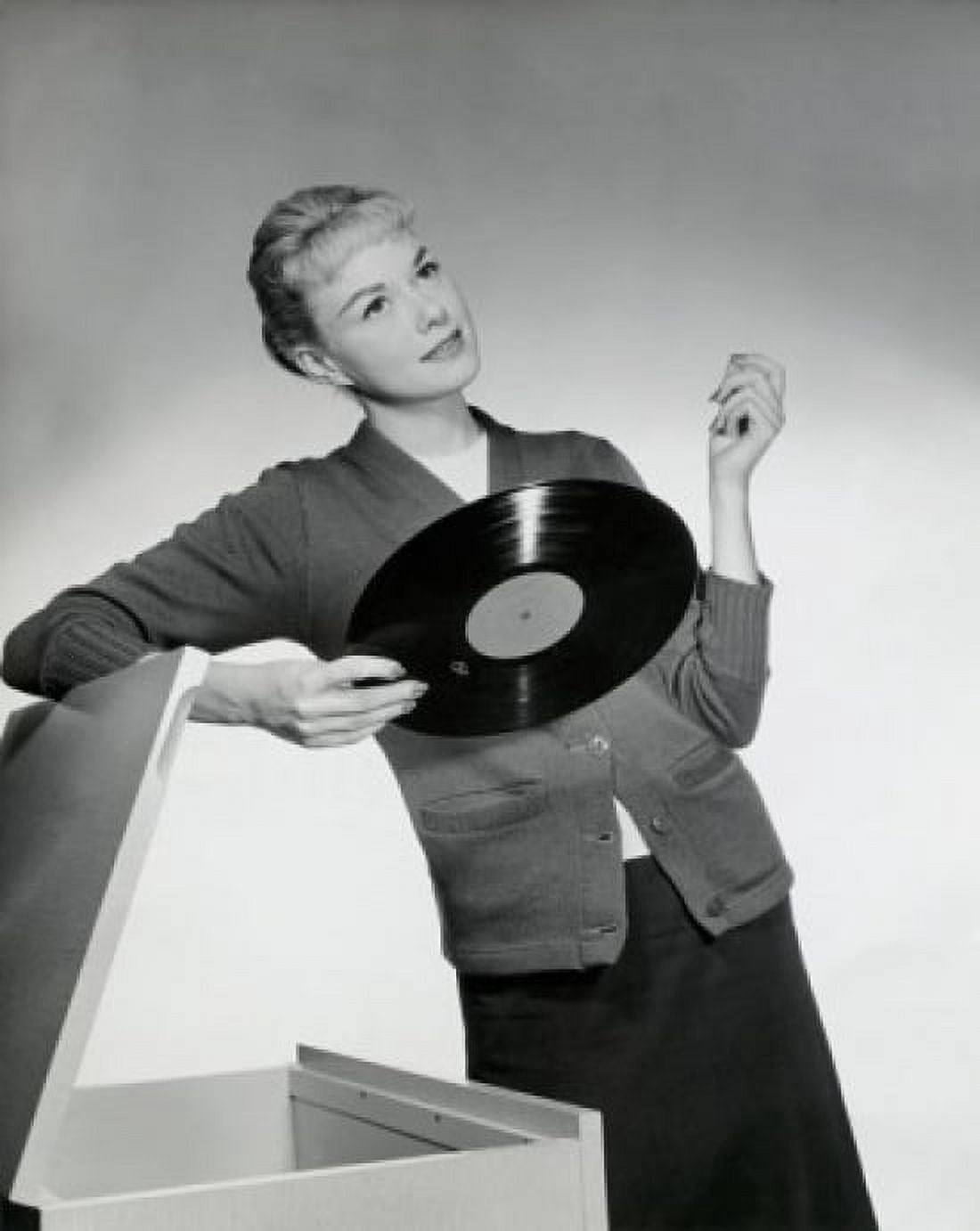 Close-up of a young woman leaning on a box and holding a record 1958 Canvas Art - (24 x 36)