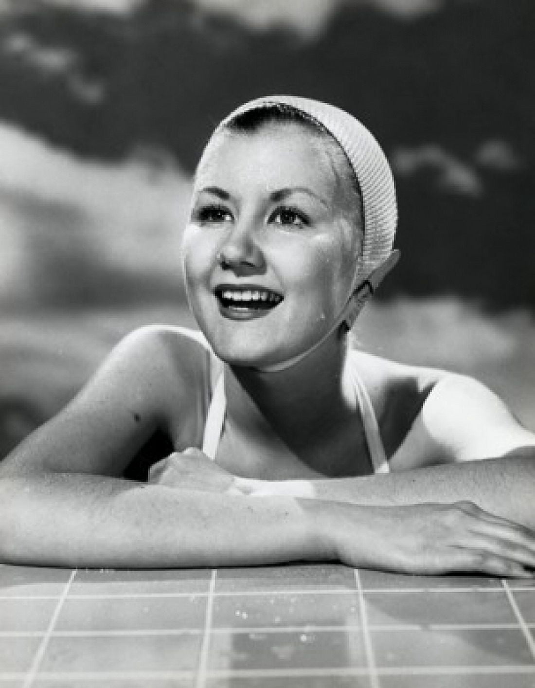 Close-up of a young woman leaning on the edge of swimming pool and smiling Canvas Art - (24 x 36)