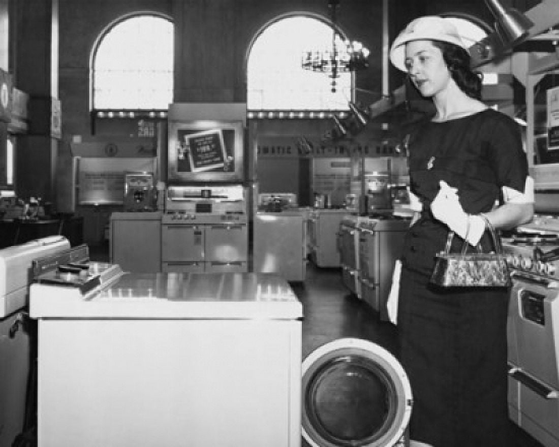 Close-up of a young woman looking at a washing machine Canvas Art - (18 x 24)