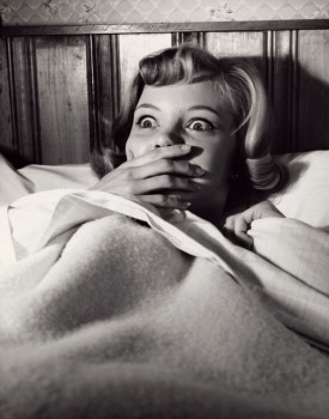 Close-up of a young woman lying in bed looking frightened Canvas Art - (18 x 24)