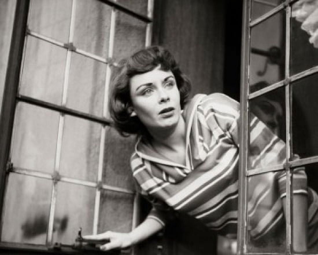 Close-up of a young woman peeking through a window Canvas Art - (18 x 24)