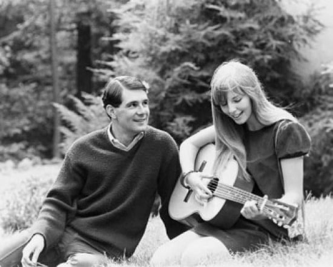 Close-up of a young woman playing a guitar with a young man sitting beside her Canvas Art - (18 x 24)
