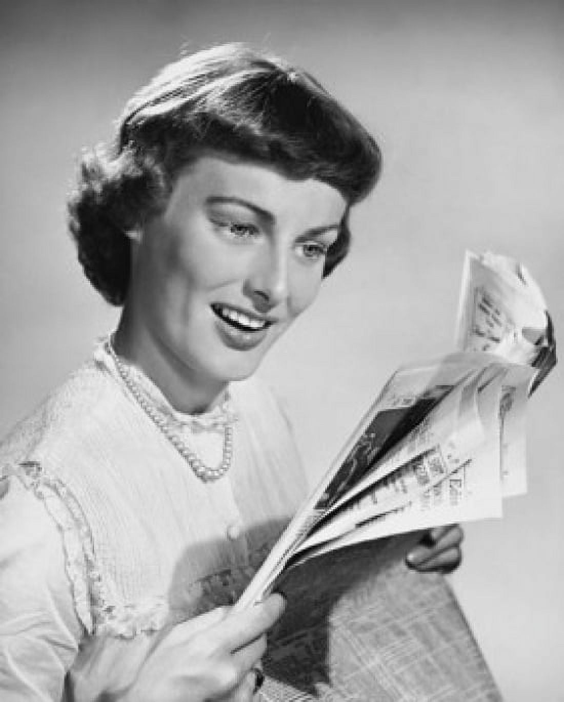 Close-up of a young woman reading a newspaper Canvas Art - (24 x 36)