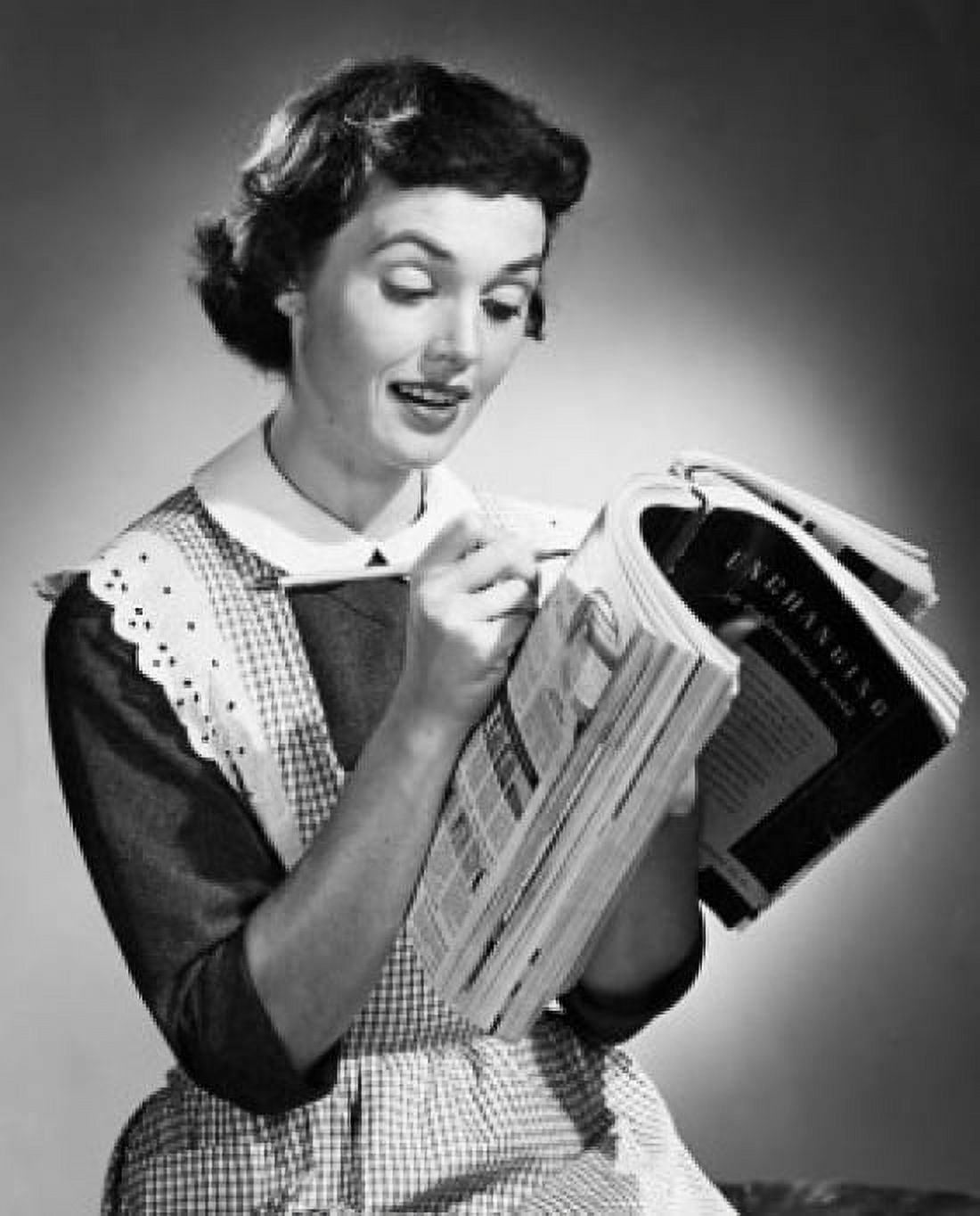 Close-up of a young woman witting on a catalogue Canvas Art - (24 x 36)