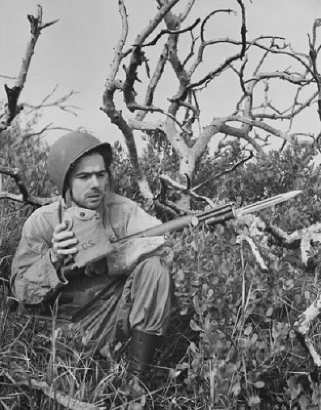 Close-up of an army soldier holding a gun and a canteen Canvas Art - (18 x 24)
