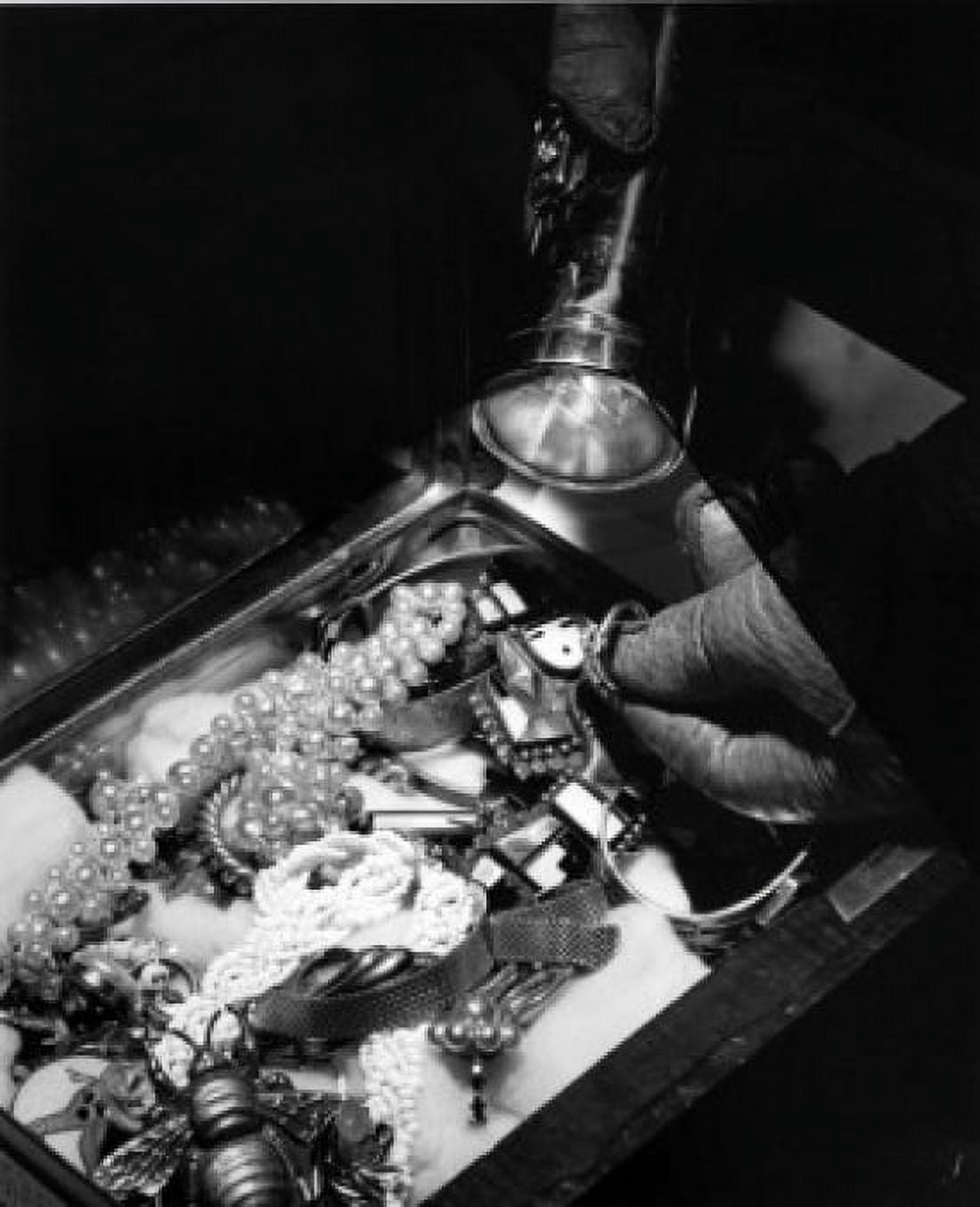 Close-up of burglar illuminating jewelry with flashlight Canvas Art - (24 x 36)