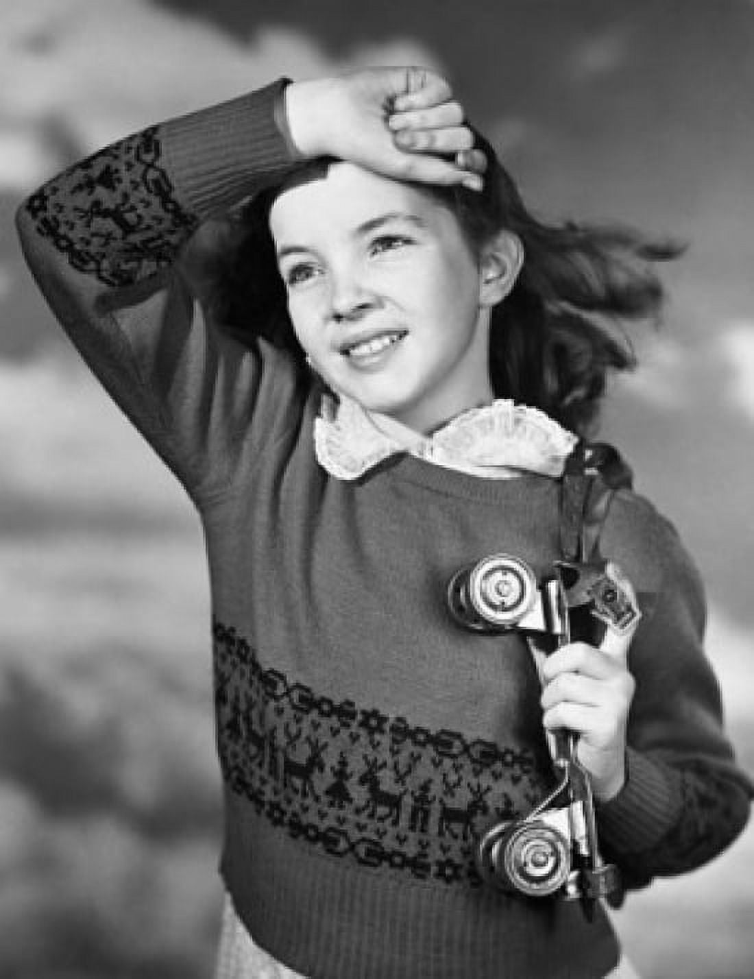 Close-up of girl holding roller skate and smiling Canvas Art - (24 x 36)